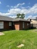 13323 S Thorntree Dr, Houston, TX 77015 - view of property exterior featuring a yard