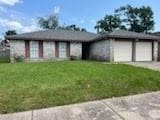 13323 S Thorntree Dr, Houston, TX 77015 - view of front of house with concrete driveway and a front lawn