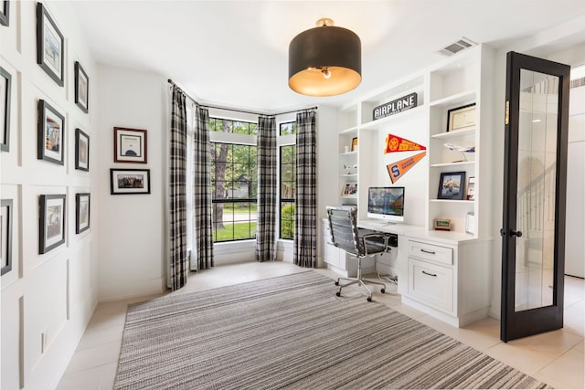 31 Wood Cove Dr, The Woodlands, TX 77381 - office area with light tile patterned floors, built in study area, french doors, and built in features