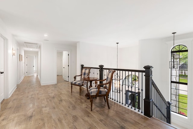 31 Wood Cove Dr, The Woodlands, TX 77381 - corridor featuring an upstairs landing, light wood finished floors, attic access, baseboards, and recessed lighting