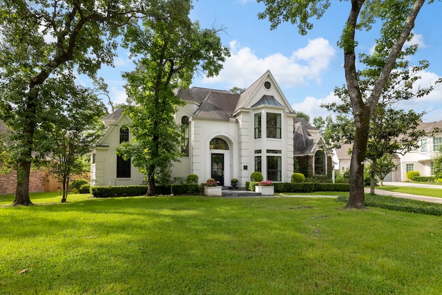 31 Wood Cove Dr, The Woodlands, TX 77381 - french provincial home featuring a front lawn