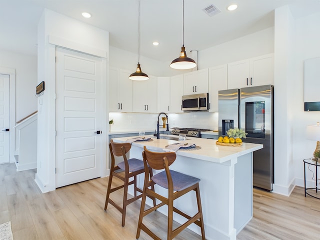 3004 Jensen Springs Ln, Houston, TX 77026 - kitchen with appliances with stainless steel finishes, light wood-style floors, light countertops, tasteful backsplash, and recessed lighting