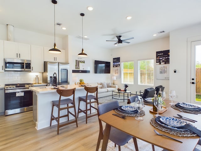 3004 Jensen Springs Ln, Houston, TX 77026 - dining area with light wood-style flooring, a ceiling fan, and recessed lighting