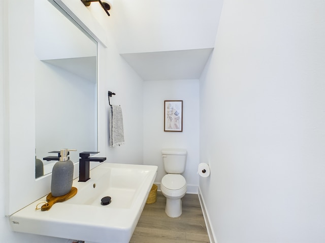 3004 Jensen Springs Ln, Houston, TX 77026 - half bath featuring wood finished floors and toilet