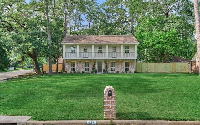 6326 Bayonne Dr, Spring, TX 77389 - view of front of home featuring a balcony and brick siding