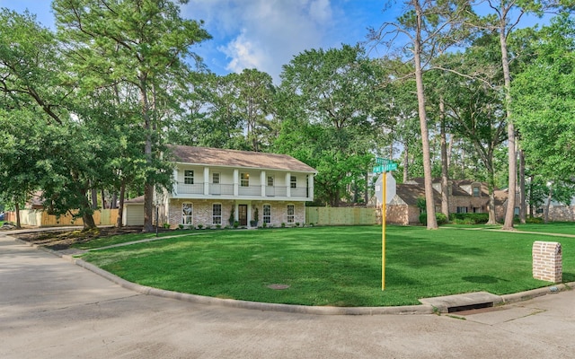 6326 Bayonne Dr, Spring, TX 77389 - view of front of property with a balcony, brick siding, covered porch, and a garage