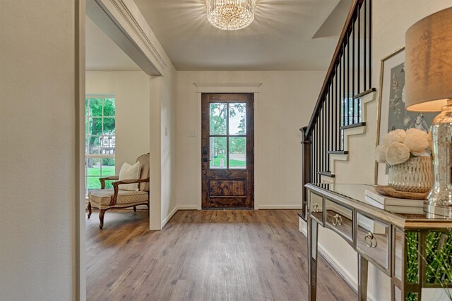 6326 Bayonne Dr, Spring, TX 77389 - entrance foyer with a chandelier, wood finished floors, stairs, and baseboards