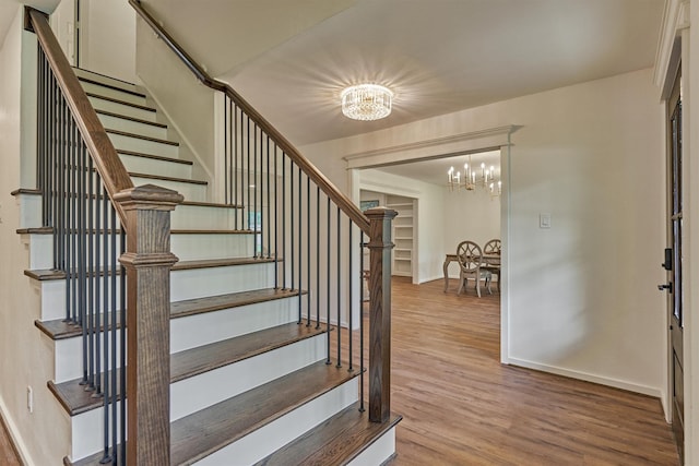 6326 Bayonne Dr, Spring, TX 77389 - stairway with a chandelier, wood finished floors, and baseboards
