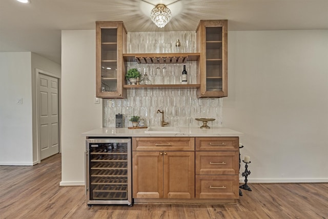 6326 Bayonne Dr, Spring, TX 77389 - indoor wet bar with beverage cooler, baseboards, decorative backsplash, and wood finished floors