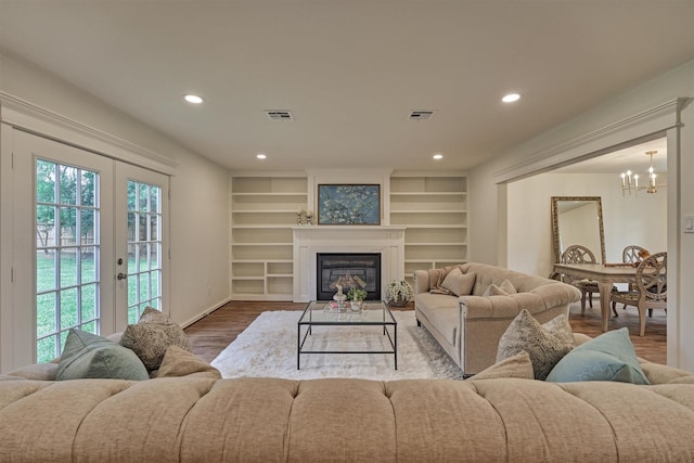 6326 Bayonne Dr, Spring, TX 77389 - living room with a chandelier, wood finished floors, recessed lighting, a glass covered fireplace, and baseboards