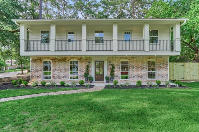 6326 Bayonne Dr, Spring, TX 77389 - view of front of home with a balcony and brick siding