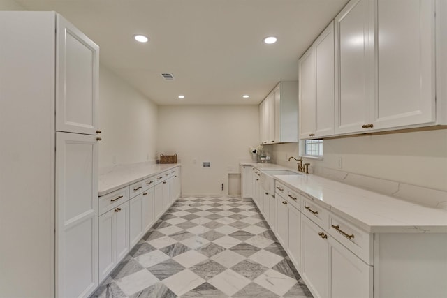 6326 Bayonne Dr, Spring, TX 77389 - kitchen with recessed lighting, white cabinets, light stone countertops, and a sink
