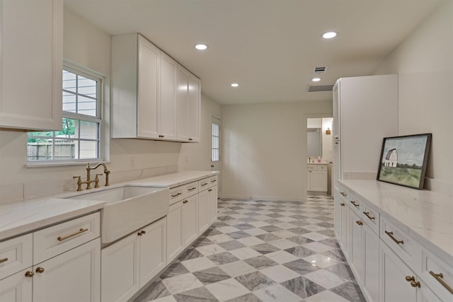 6326 Bayonne Dr, Spring, TX 77389 - kitchen featuring a sink, healthy amount of natural light, white cabinetry, light stone countertops, and recessed lighting