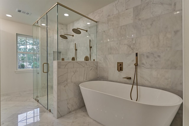 6326 Bayonne Dr, Spring, TX 77389 - bathroom with a shower stall, tile walls, a freestanding bath, marble tiled floors, and recessed lighting