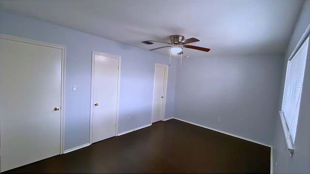 13419 Greenway Dr, Sugar Land, TX 77498 - unfurnished bedroom featuring a ceiling fan, baseboards, and dark wood-style floors