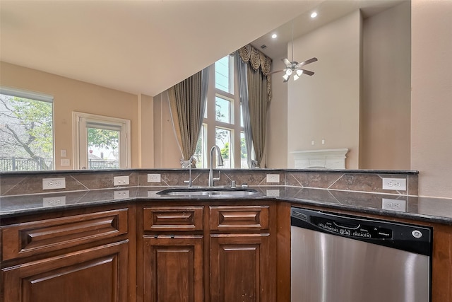 4131 Regal Stone Ln, Sugar Land, TX 77479 - kitchen featuring stainless steel dishwasher, a sink, a ceiling fan, dark stone countertops, and tasteful backsplash