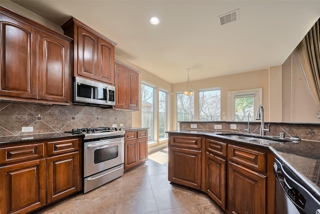 4131 Regal Stone Ln, Sugar Land, TX 77479 - kitchen with appliances with stainless steel finishes, a sink, backsplash, healthy amount of natural light, and recessed lighting
