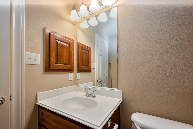 4131 Regal Stone Ln, Sugar Land, TX 77479 - bathroom featuring vanity, toilet, and a textured wall