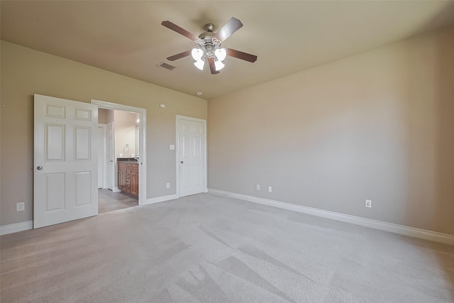 4131 Regal Stone Ln, Sugar Land, TX 77479 - unfurnished bedroom with baseboards, light carpet, and connected bathroom