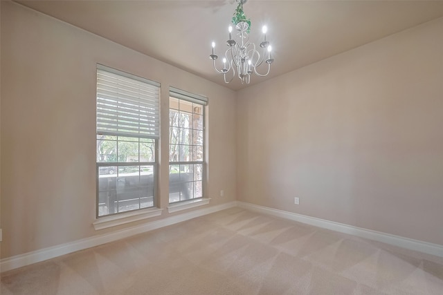 4131 Regal Stone Ln, Sugar Land, TX 77479 - spare room with baseboards, a chandelier, and light colored carpet