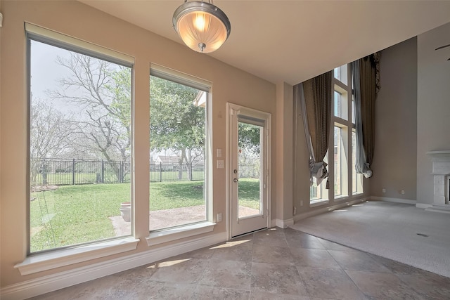 4131 Regal Stone Ln, Sugar Land, TX 77479 - doorway to outside with baseboards, stone finish flooring, and carpet floors