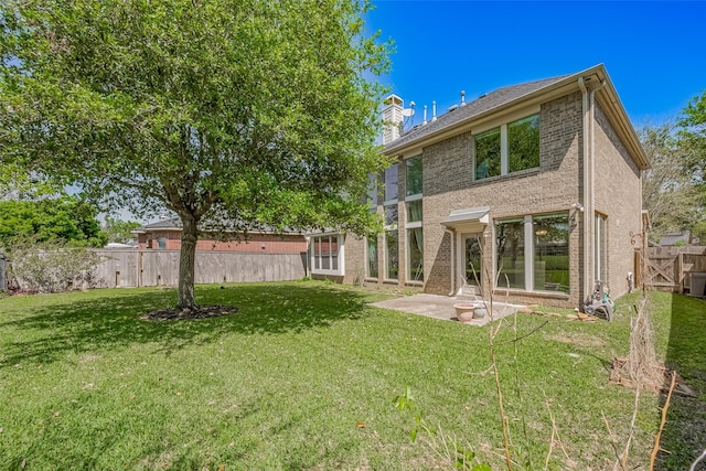 4131 Regal Stone Ln, Sugar Land, TX 77479 - rear view of house with a patio, brick siding, and a chimney