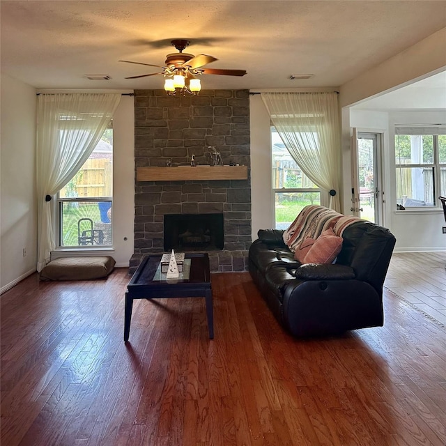 3231 Brinton Trails Ln, Katy, TX 77494 - living room featuring wood-type flooring, ceiling fan, baseboards, and a stone fireplace
