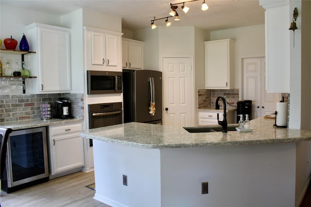 3231 Brinton Trails Ln, Katy, TX 77494 - kitchen featuring wine cooler, appliances with stainless steel finishes, decorative backsplash, and white cabinets