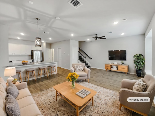 8022 Scanlan Trce, Missouri City, TX 77459 - living area with light wood finished floors, stairway, recessed lighting, baseboards, and a ceiling fan