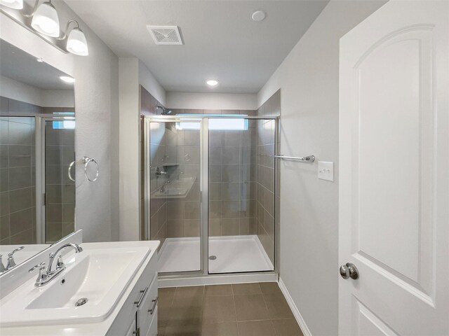 8022 Scanlan Trce, Missouri City, TX 77459 - bathroom with tile patterned floors, vanity, a stall shower, and baseboards