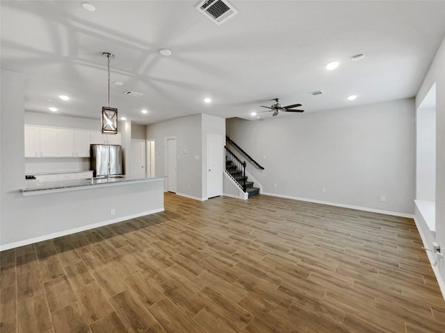 8022 Scanlan Trce, Missouri City, TX 77459 - unfurnished living room with stairway, wood finished floors, baseboards, recessed lighting, and a ceiling fan