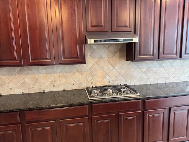 11703 Sterling Brook St, Pearland, TX 77584 - kitchen featuring dark brown cabinets, stainless steel gas stovetop, under cabinet range hood, and dark stone countertops