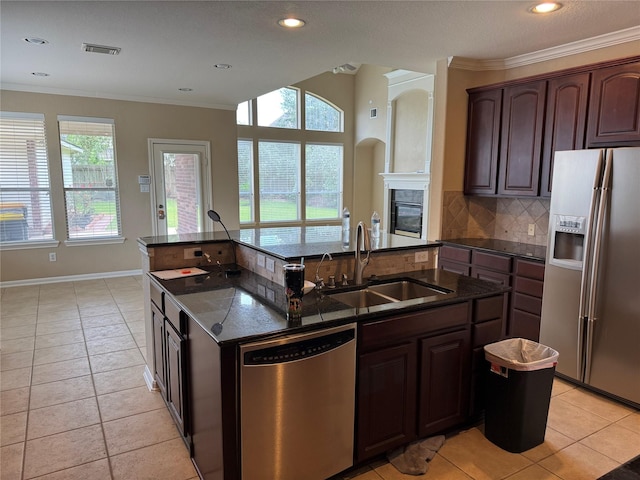 11703 Sterling Brook St, Pearland, TX 77584 - kitchen with stainless steel appliances, a sink, an island with sink, backsplash, and crown molding