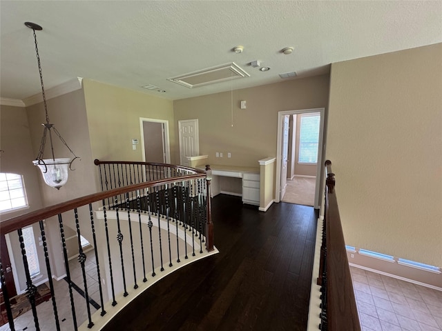 11703 Sterling Brook St, Pearland, TX 77584 - corridor featuring attic access, an upstairs landing, baseboards, and a textured ceiling