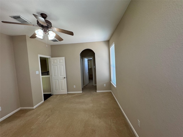 11703 Sterling Brook St, Pearland, TX 77584 - carpeted empty room with arched walkways, a ceiling fan, and baseboards