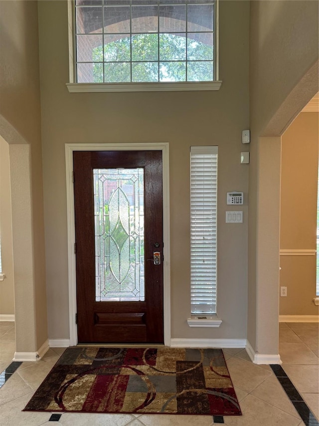 11703 Sterling Brook St, Pearland, TX 77584 - foyer entrance featuring a high ceiling, tile patterned flooring, plenty of natural light, and baseboards