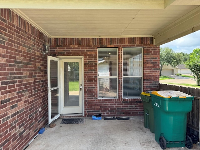 11703 Sterling Brook St, Pearland, TX 77584 - view of exterior entry featuring a patio and brick siding