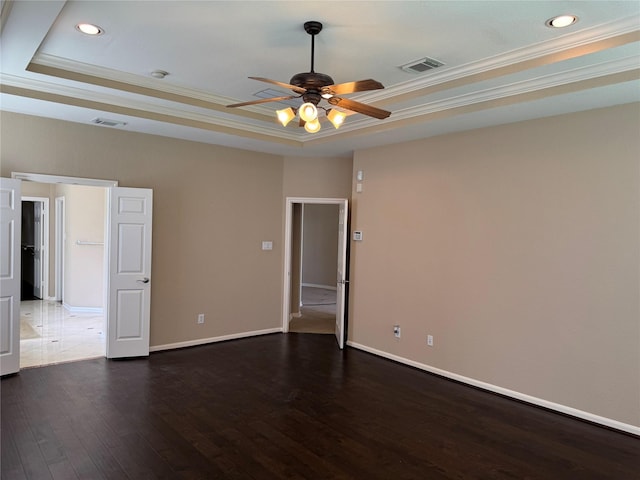 11703 Sterling Brook St, Pearland, TX 77584 - spare room with a tray ceiling, ceiling fan, ornamental molding, dark wood-style floors, and recessed lighting