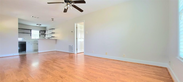 1401 Truxillo St, Houston, TX 77004 - unfurnished living room featuring light wood-style floors, a ceiling fan, baseboards, and a sink