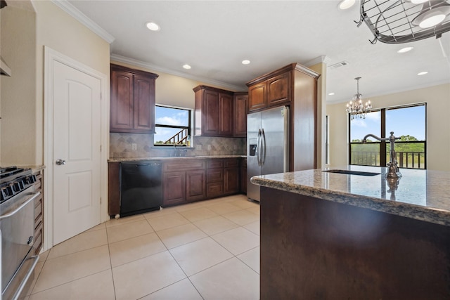 303 Winkler St, Baytown, TX 77520 - kitchen with appliances with stainless steel finishes, crown molding, stone countertops, backsplash, and a chandelier