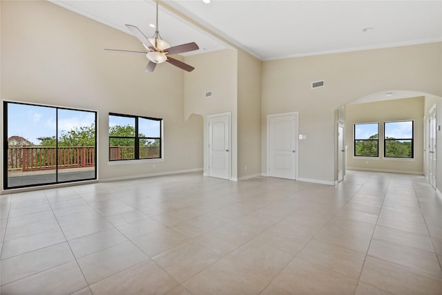 303 Winkler St, Baytown, TX 77520 - unfurnished room with arched walkways, ceiling fan, plenty of natural light, light tile patterned floors, and high vaulted ceiling