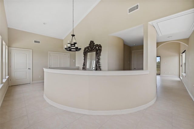 303 Winkler St, Baytown, TX 77520 - hall with light tile patterned floors, high vaulted ceiling, baseboards, a chandelier, and crown molding