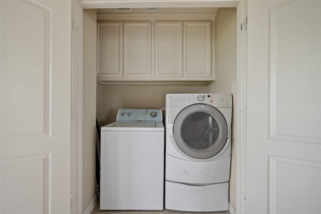 303 Winkler St, Baytown, TX 77520 - laundry area featuring independent washer and dryer and cabinet space