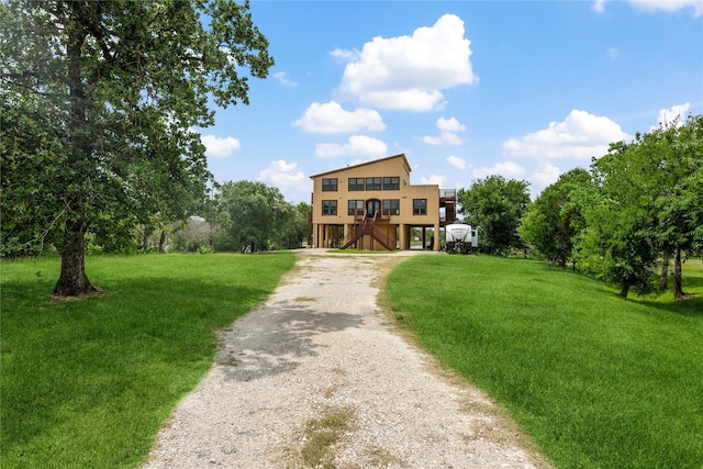 303 Winkler St, Baytown, TX 77520 - view of front of home featuring gravel driveway, a front lawn, and stairway