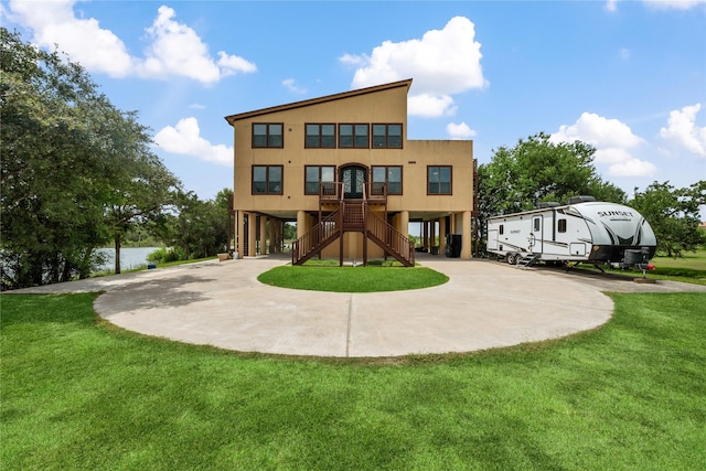 303 Winkler St, Baytown, TX 77520 - back of property with stairs, a yard, a carport, and curved driveway