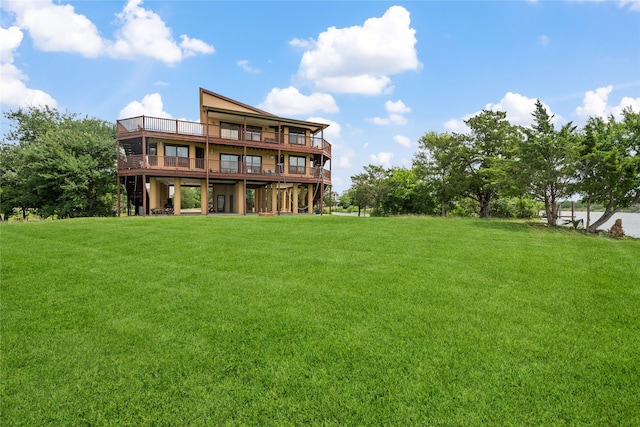 303 Winkler St, Baytown, TX 77520 - back of property featuring a lawn and a wooden deck