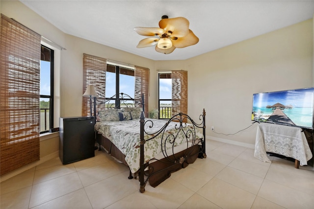 303 Winkler St, Baytown, TX 77520 - bedroom with baseboards, a ceiling fan, and light tile patterned floors