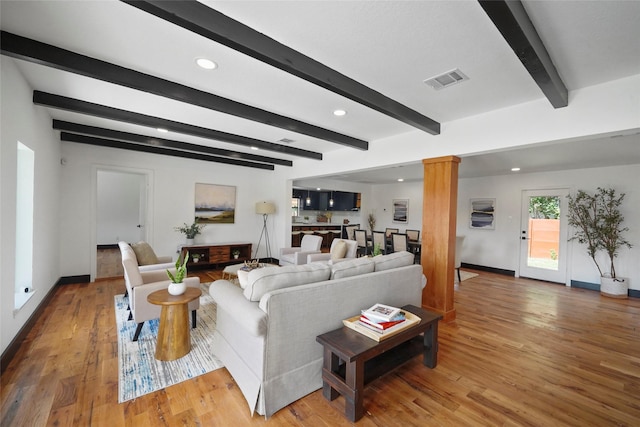 701 W 39th St, Houston, TX 77018 - living room featuring decorative columns, beamed ceiling, wood finished floors, baseboards, and recessed lighting