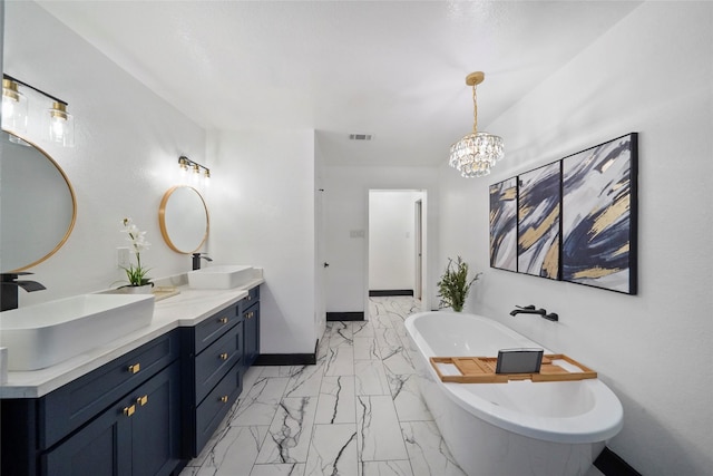 701 W 39th St, Houston, TX 77018 - full bath featuring marble look tile flooring, a soaking tub, double vanity, a chandelier, and baseboards
