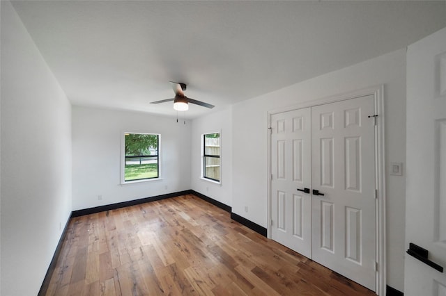 701 W 39th St, Houston, TX 77018 - unfurnished bedroom with wood finished floors, baseboards, a ceiling fan, and a closet